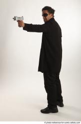 Man Adult Average Black Fighting with gun Standing poses Coat